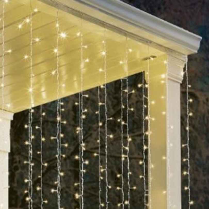 The Curtain Icicle Lights 500 Micro LED Set - Warm White from Available for Pick-Up & Delivery drapes vertically from your porch edge, creating a stunning curtain of light—ideal for festive and holiday décor.