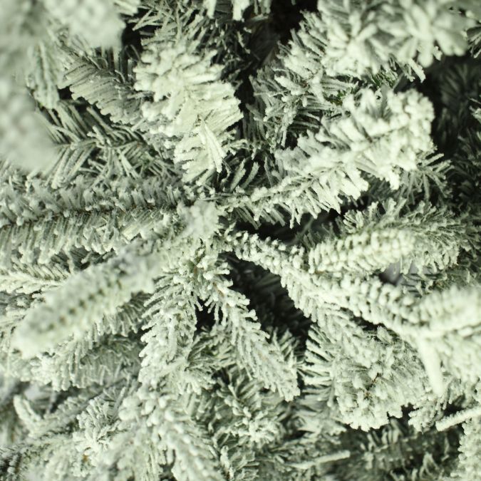 Close-up of Nordic Flocked Fir Multi-Function Lights 7.5 Ft. branches covered in artificial white flocking.