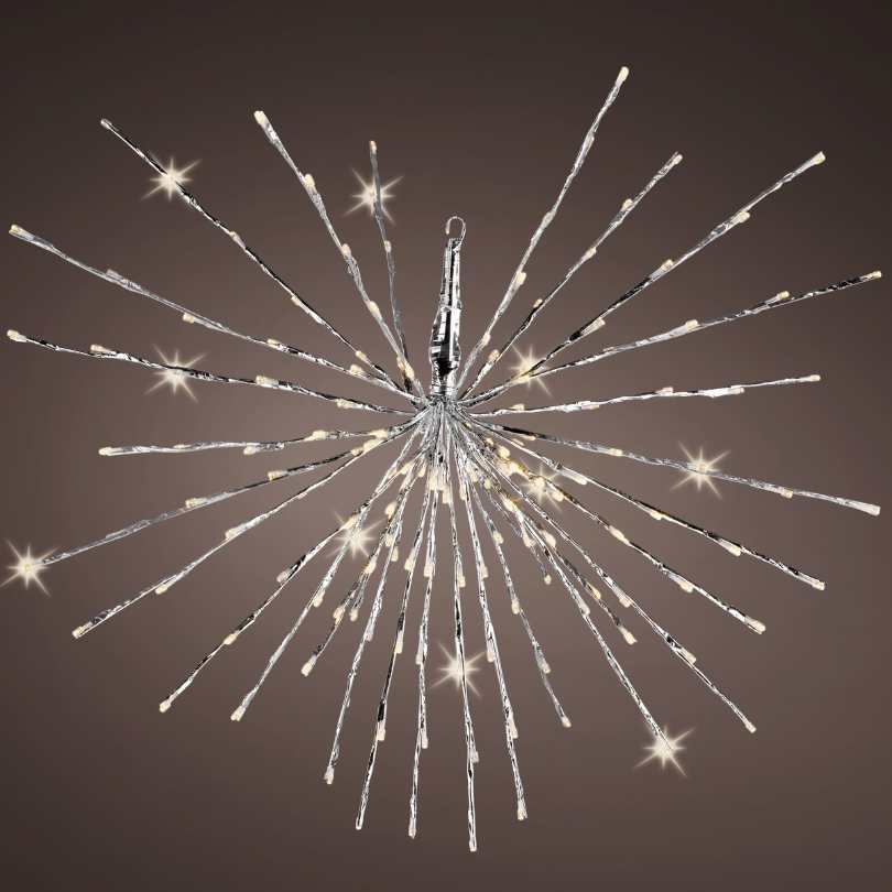 The Polestar Flashing LED 160 ct. Silver Decoration by Available for Pickup & Delivery features a modern, starburst design with silver rods and warm white LEDs glowing at the tips, set against a dark brown backdrop.
