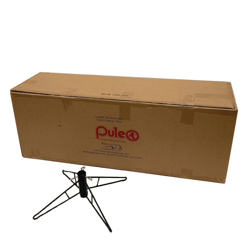 A rectangular cardboard shipping box for a Southern Fir Slim Warm White LED Lights 12 Ft. artificial Christmas tree placed behind a black metal tree stand.
