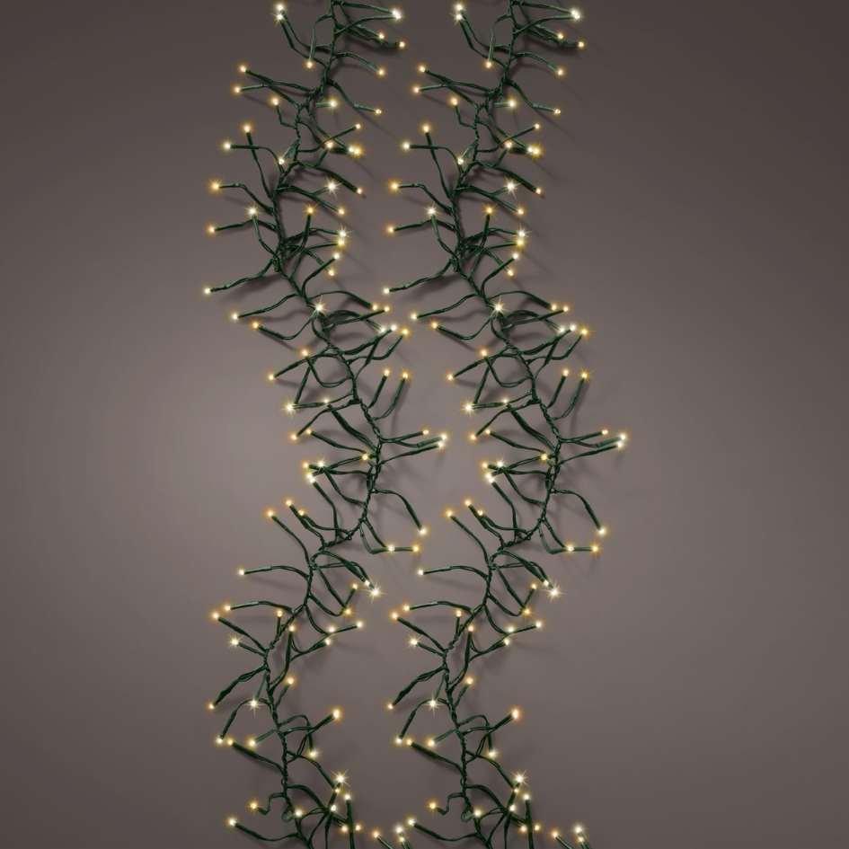 The Cluster LED 768 ct. String Lights Warm White from Available for Pick-Up & Delivery feature two vertical strands with green wiring, evenly spaced LEDs, softly glowing against a neutral background.