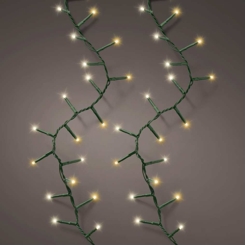 Two strands of LED 1000 ct. Compact String Lights in warm white and cool white, with green wiring, are displayed vertically against a gray background—an ideal festive accent for your holiday décor. Available for Pick-Up & Delivery.