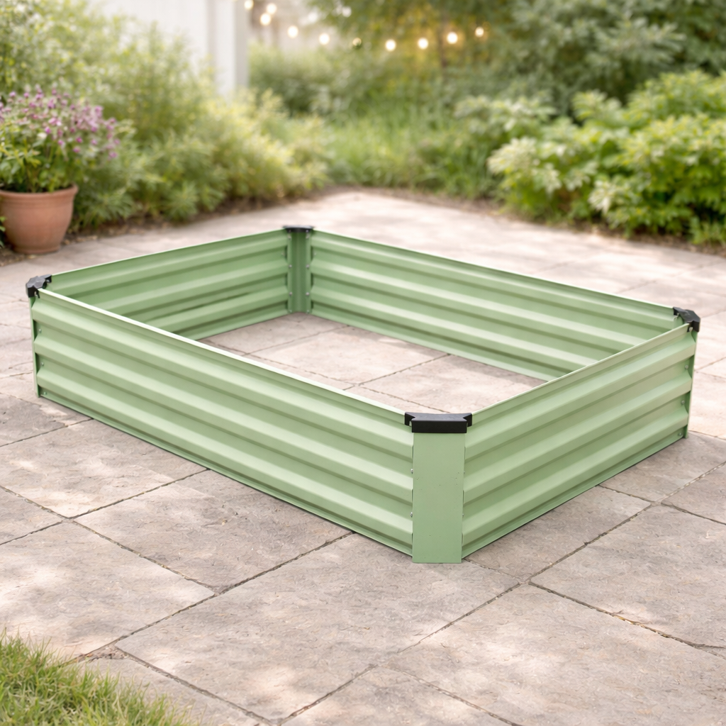 The Pick-Up & Local Delivery Only Raised Bed - Rectangle - Green sits on a stone patio with grass, potted plants, and lush greenery in a backyard garden.