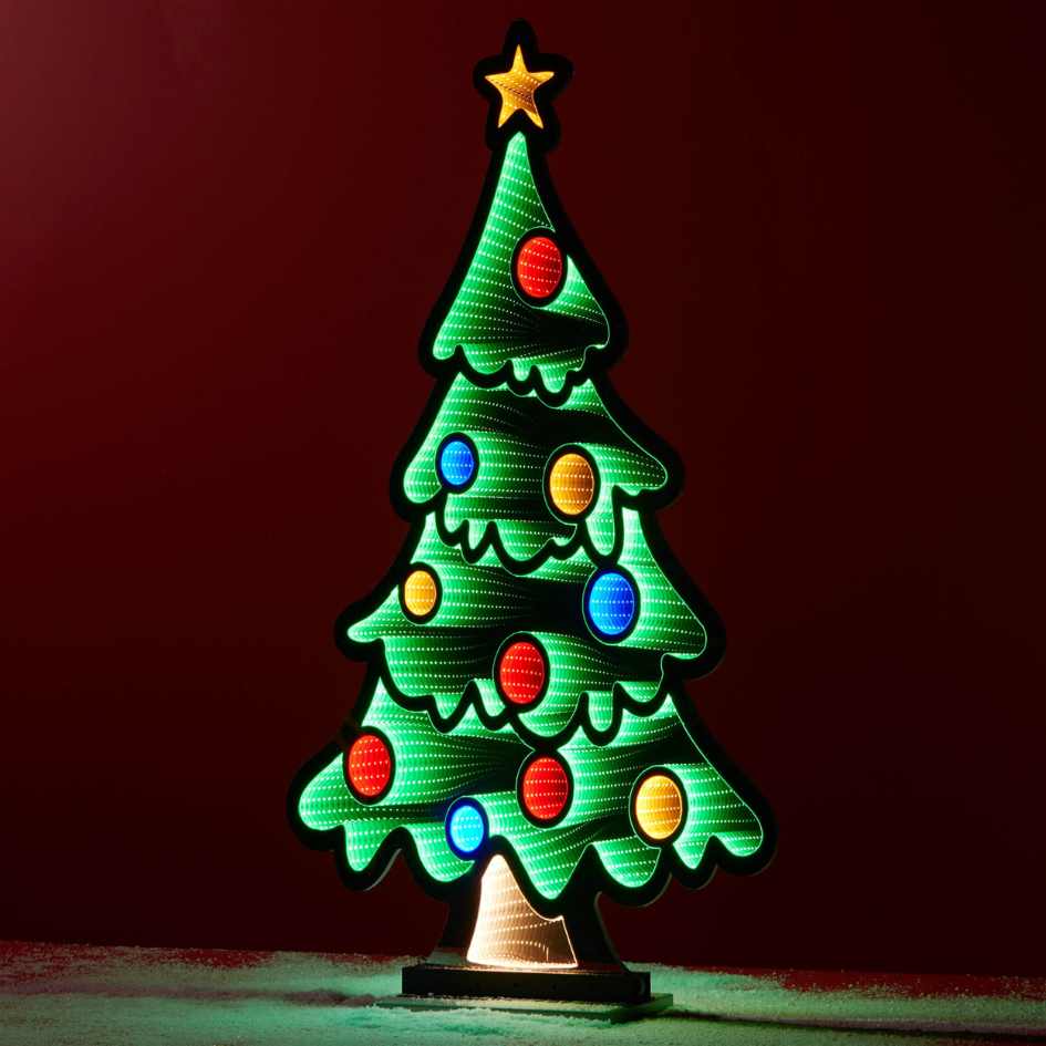 The Infinity Light – Tree with Ornaments - 47" from Available for Pick-Up & Delivery features a bright, stylized Christmas tree with colorful ornaments, yellow star topper, and snowy base—ideal for festive holiday displays.