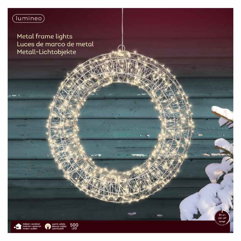 The 15-inch Micro LED Lit Wreath by Available for Pick-Up & Delivery features warm white lights on a metal frame, glowing beautifully as outdoor décor. Packaging presents this festive wreath in three languages.