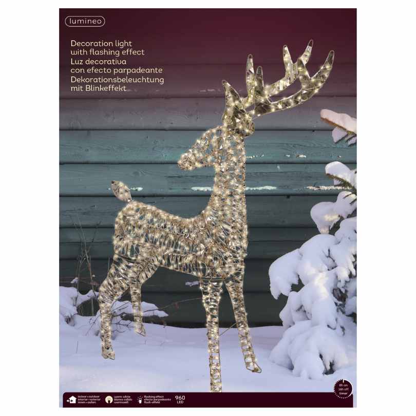The Micro LED Standing Lit Reindeer – Warm White Lights from Available for Pick-Up & Delivery brings a magical glow to your outdoor décor, shining beautifully in the snow by a green wall amid snow-dusted branches.