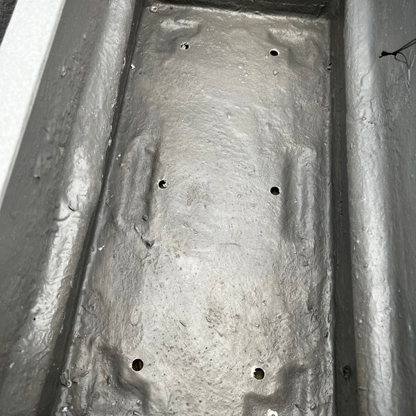 A close-up of the Gloucester Trough Planter by Pick-Up & Local Delivery Only shows its rectangular metal surface with six circular holes and a textured, durable finish, ideal for industrial or outdoor spaces. Size: 30x15, color: white.