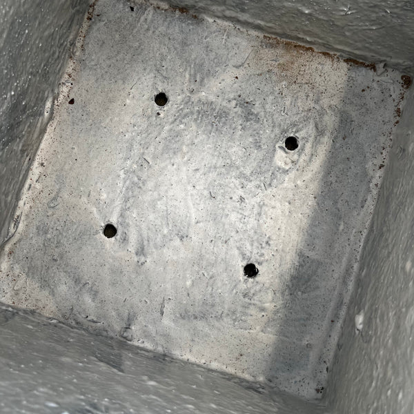 A close-up of the 22-inch Sydney Cube Planter in White by Pick-Up & Local Delivery Only, featuring a sturdy concrete finish with four circular drainage holes and subtle surface texture, ideal for outdoor weather-resistant use.