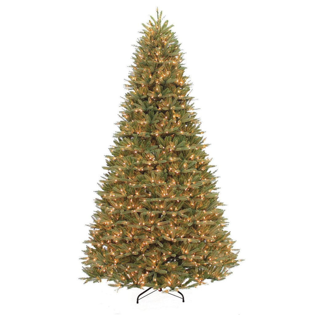 The Washington Valley Spruce Warm White LED Lights 6.5 Ft. by Available for Pick-Up & Delivery features a lifelike, tall Christmas tree on a black metal stand, glowing with white LED lights against a plain white background.