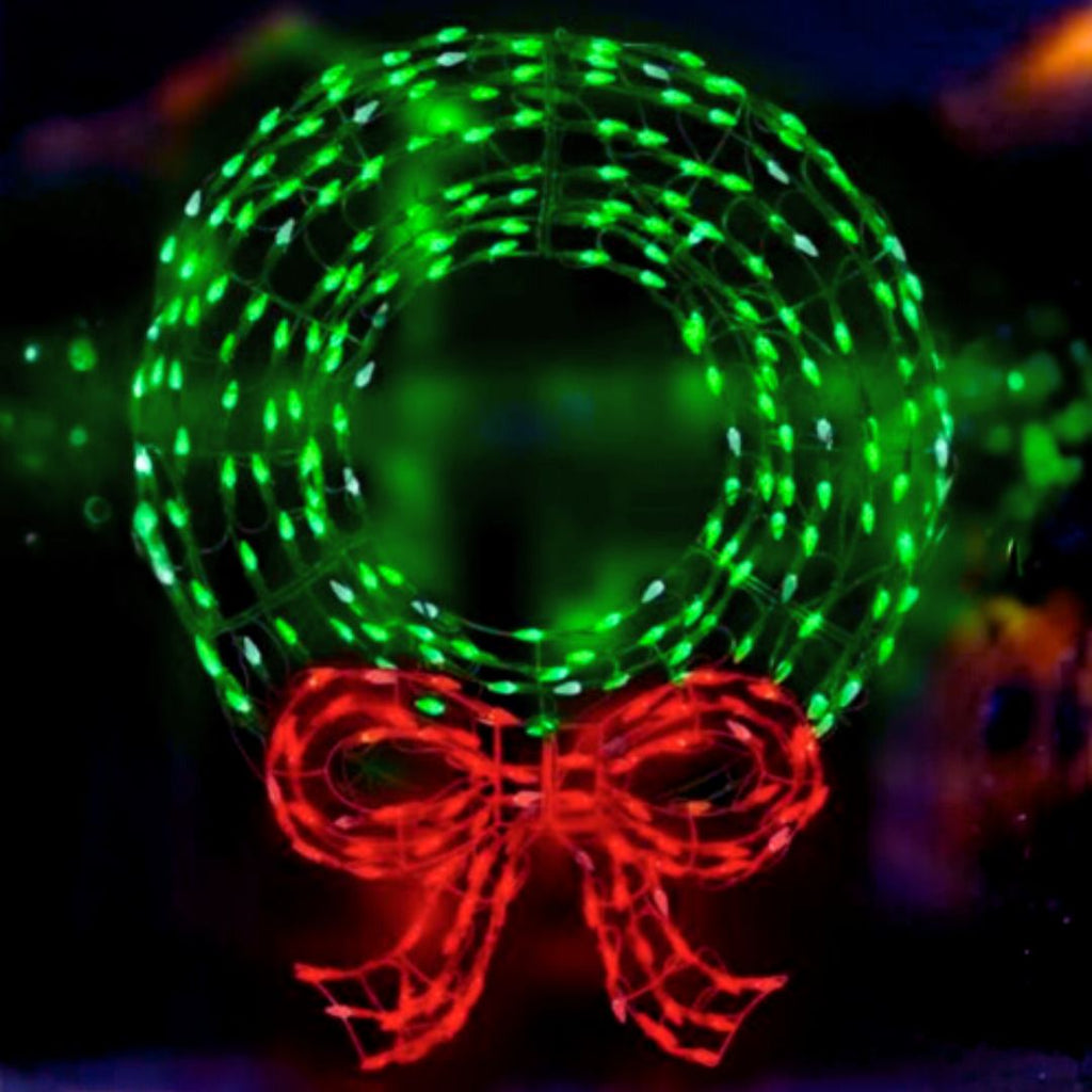 The 36" Lit Wire Wreath with Bow by Available for Pick-Up & Delivery features green LED lights and a bright red bow, creating the perfect outdoor Christmas decor that stands out beautifully at night.