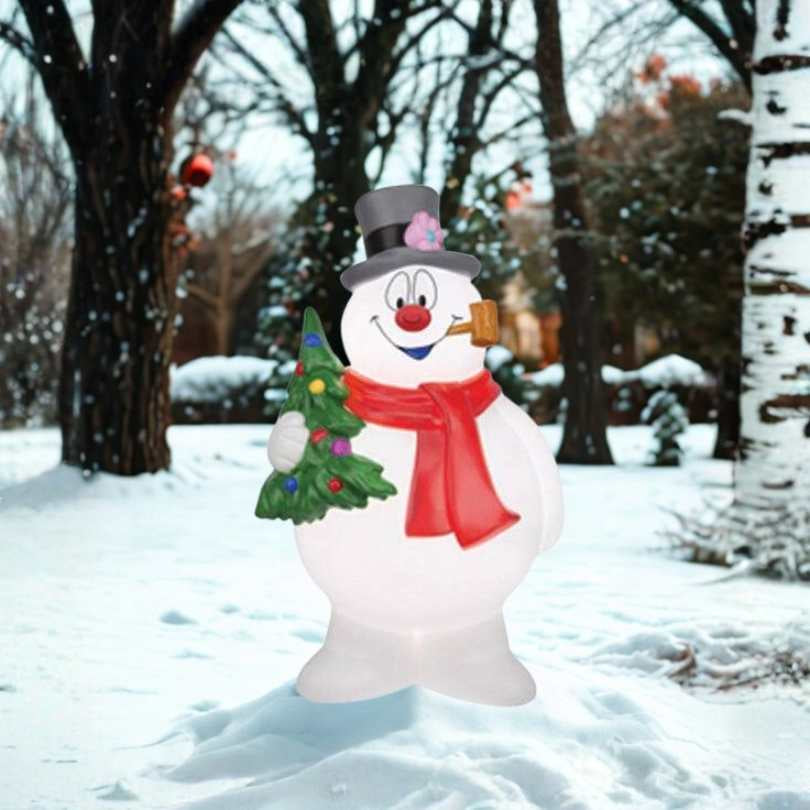 Brighten your yard with the 24” Blow Mold Frosty the Snowman with Tree, featuring a jolly snowman and festive evergreen. Perfect for outdoor Christmas décor and available for pick-up or delivery!.